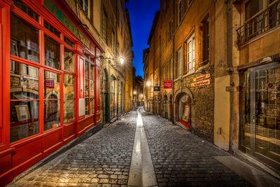 Blue hour in the Beef street in the old Lyon. 
It is a paved pedestrian street in the district of Old Lyon, in the 5th district of Lyon. Representative of Renaissance architecture of the district, it is bordered only by old houses, the sixteenth or seventeenth century. The street connects the stree of Gadagne which it extends after the square of 