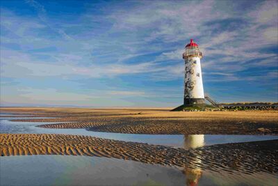 Talacre Lighthouse when the tide is out. The apparent lean of the structure is not a technical fault, it really does lean like that.